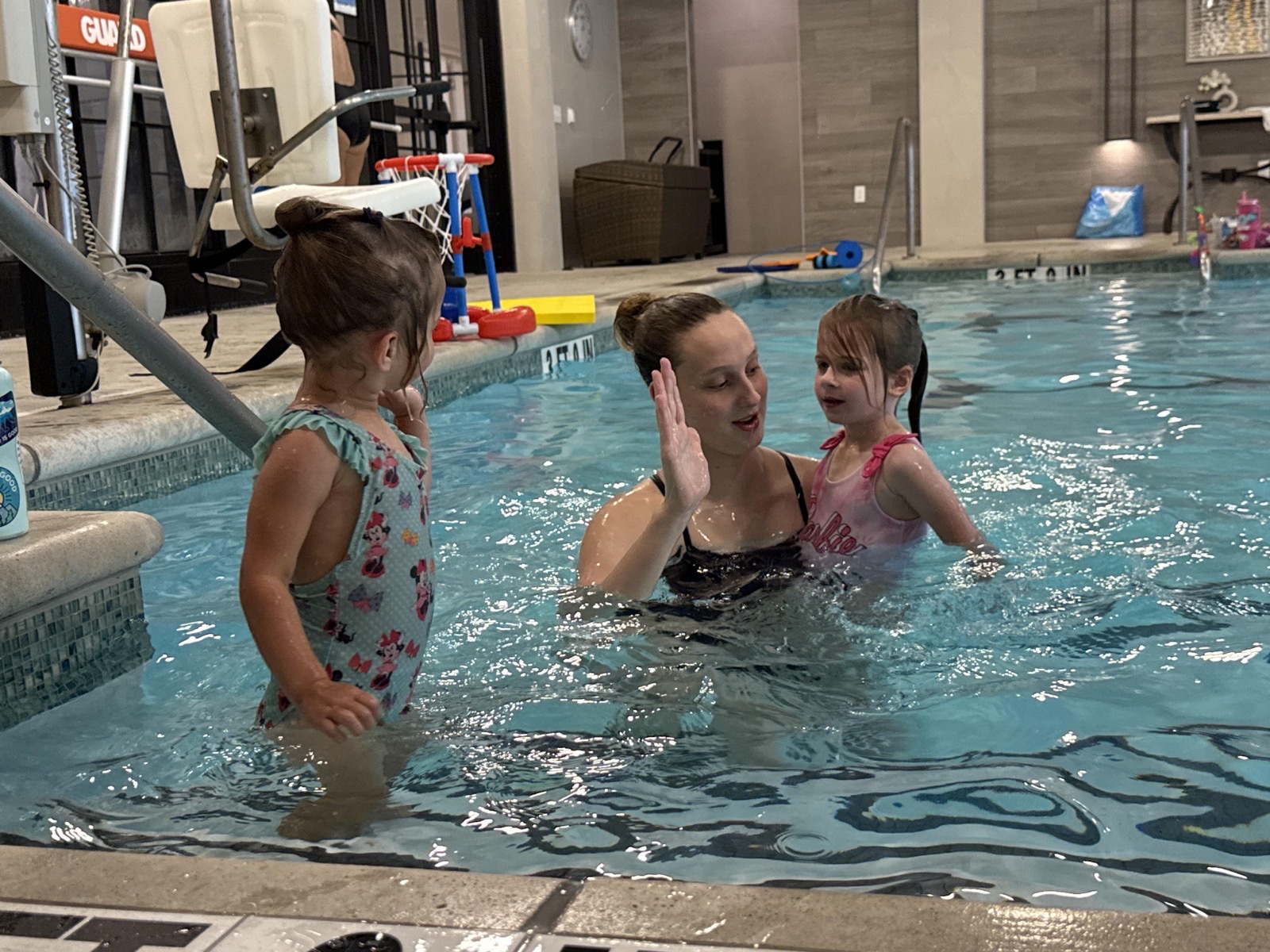 Semi-private swim lesson — two swimmers sharing instruction